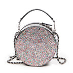 Bolso de hombro CC redondo de piel charol con purpurina negra y cadena cruzada