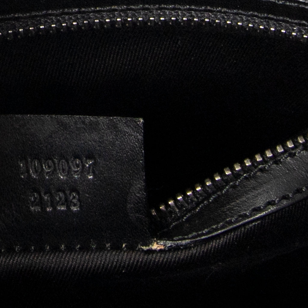 Bandolera con correa trenzada en lona monogramada negra
