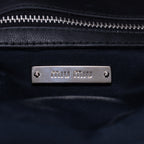 Clutch de cristal con efecto cloqué en piel de napa negra Gaufre