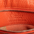 Bolso de mano de bambú con asa superior de cuero granulado naranja