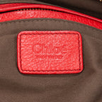 Bolso de hombro mediano Marcie Saddle Piel de becerro granulada roja